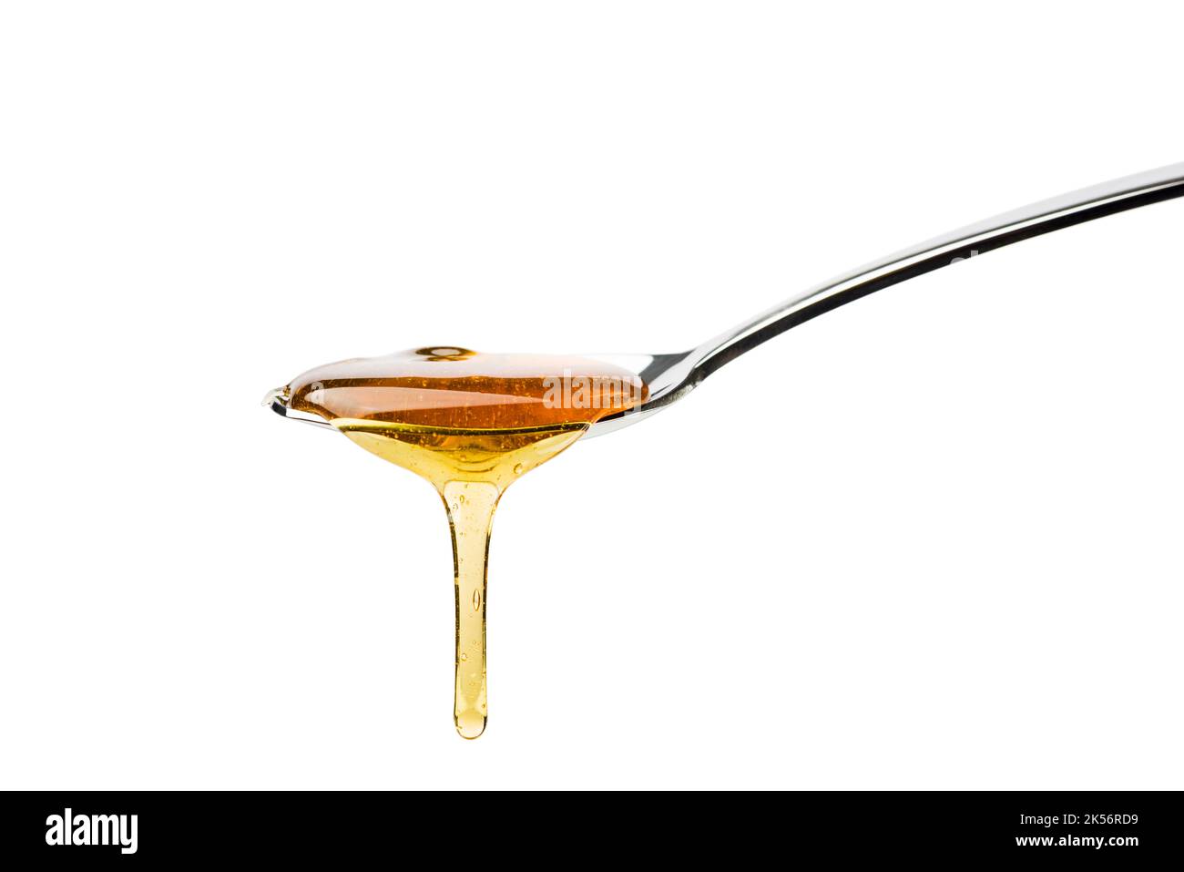 Honey dripping from spoon, isolated on white. Stock Photo