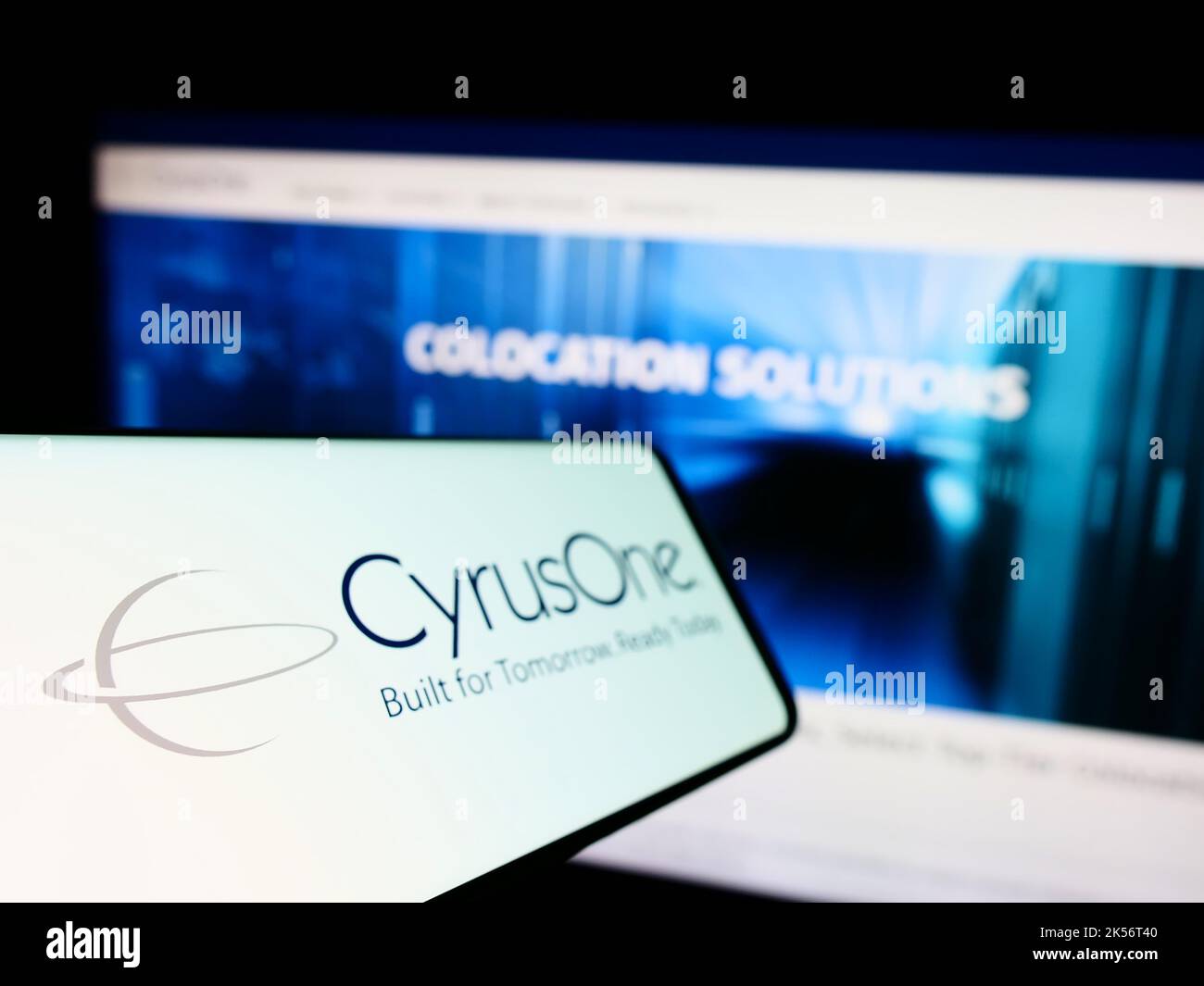 Smartphone with logo of American data center company CyrusOne LLC on screen in front of business website. Focus on left of phone display. Stock Photo