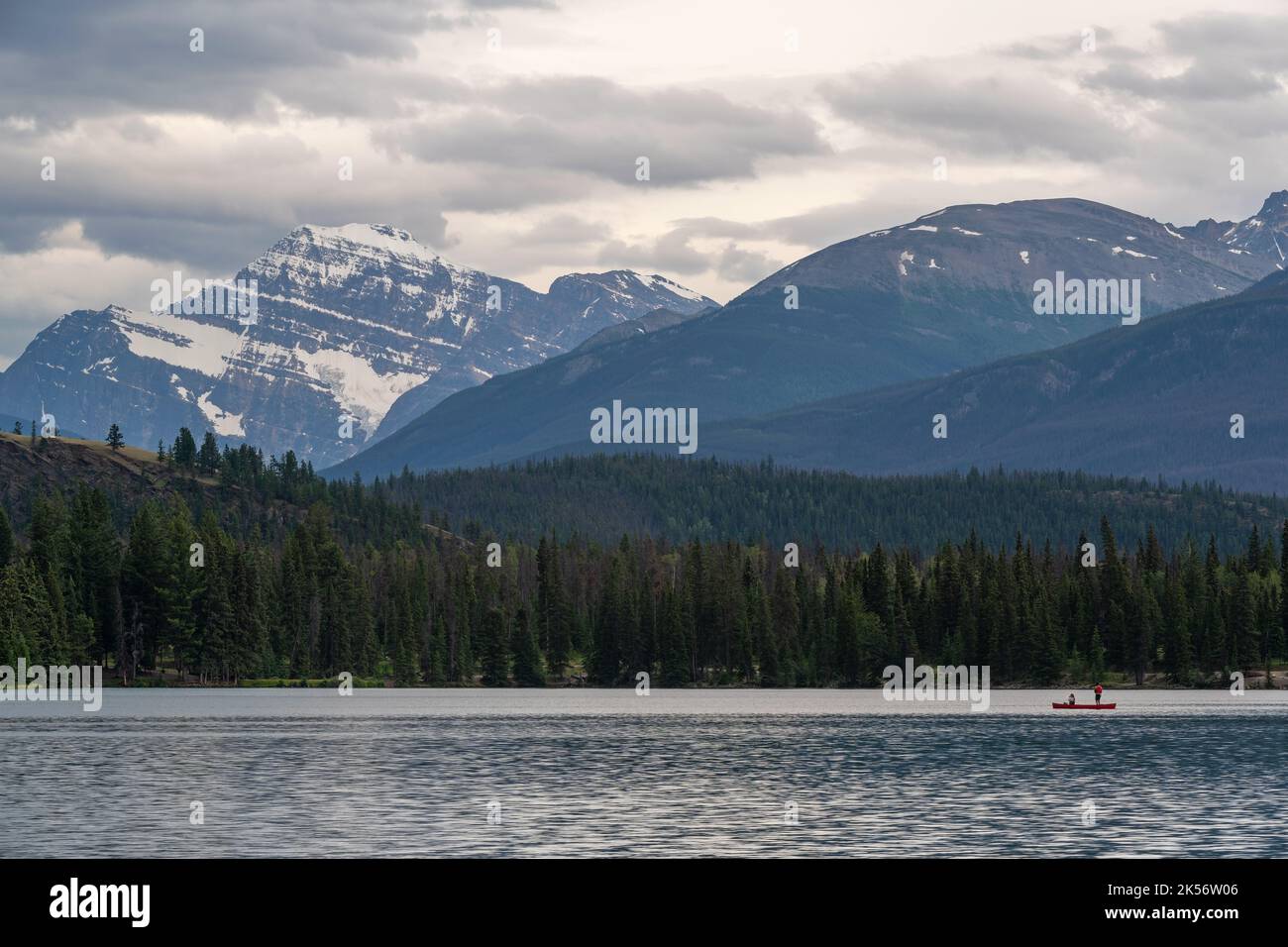 Two people on canoe fishing on Lake Beauvert with Mount Edith Cavell, Jasper national park, Alberta, Canada. Stock Photo