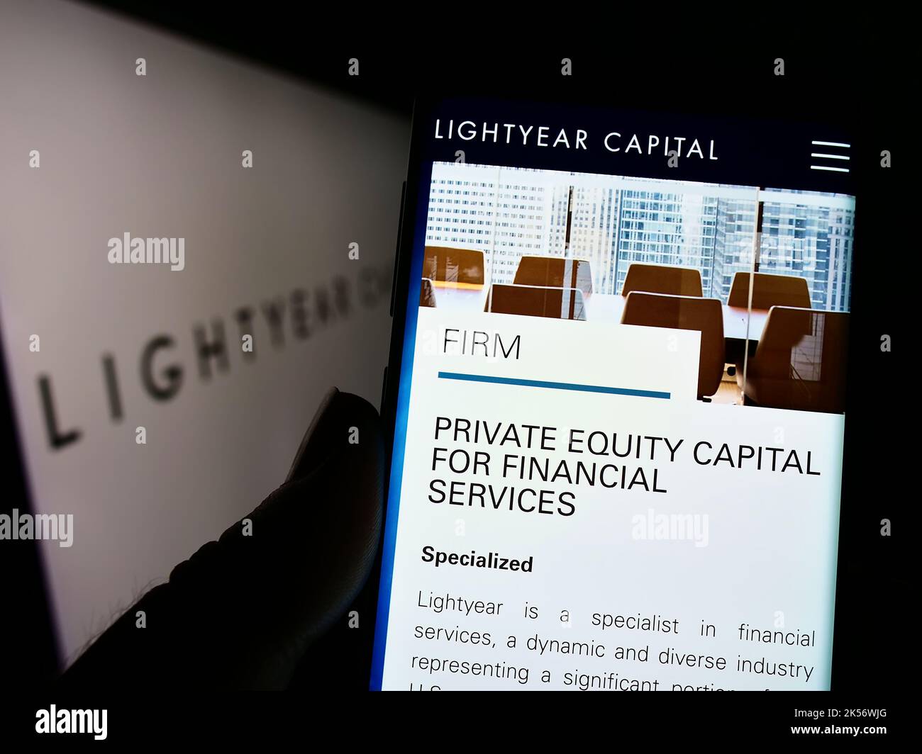 Person holding mobilephone with website of US private equity company Lightyear Capital on screen with logo. Focus on center of phone display. Stock Photo