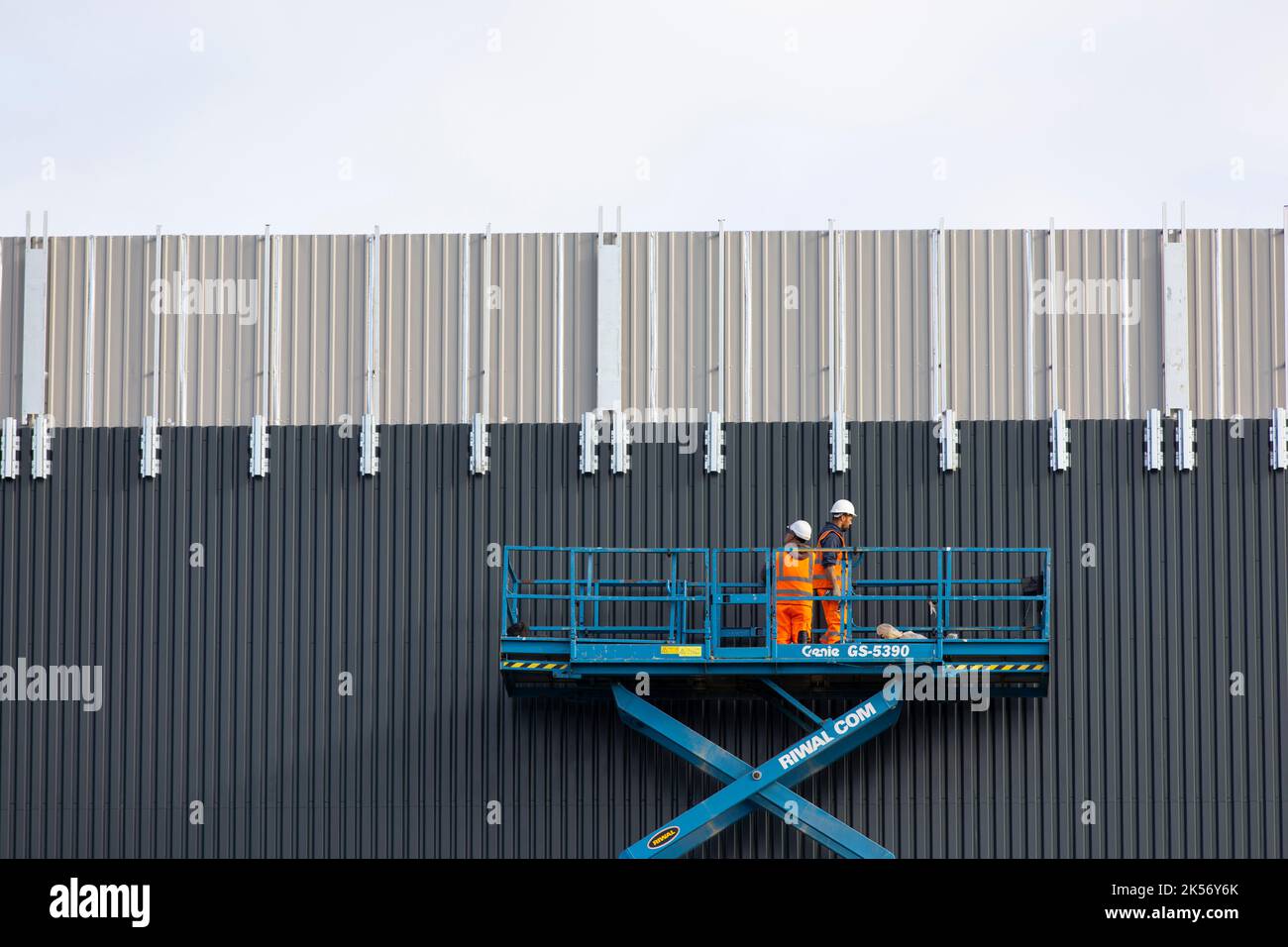 Worked installing cladding on industrial building using scissor lift