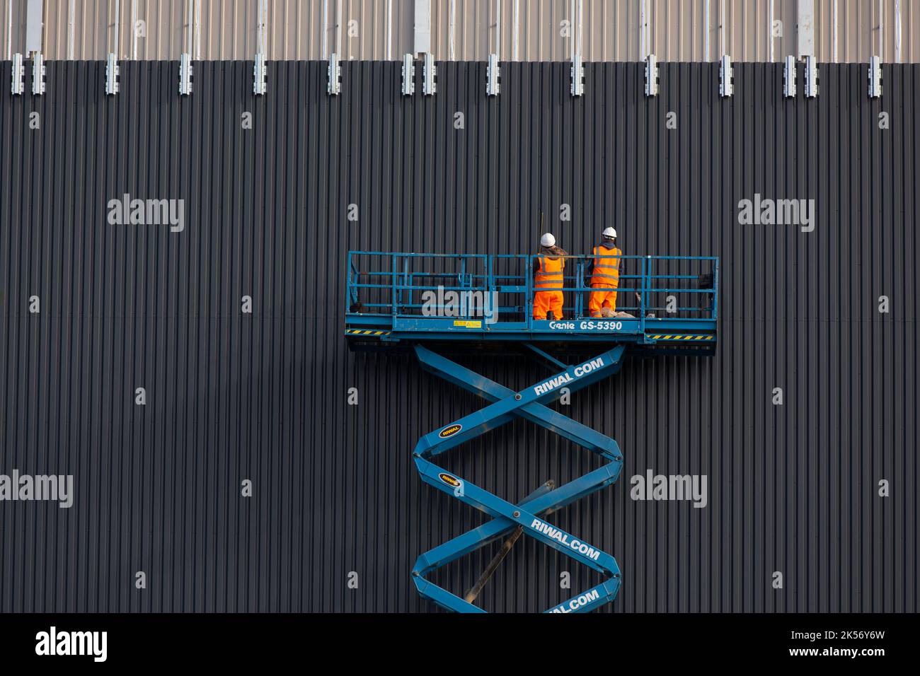 Worked installing cladding on industrial building using scissor lift