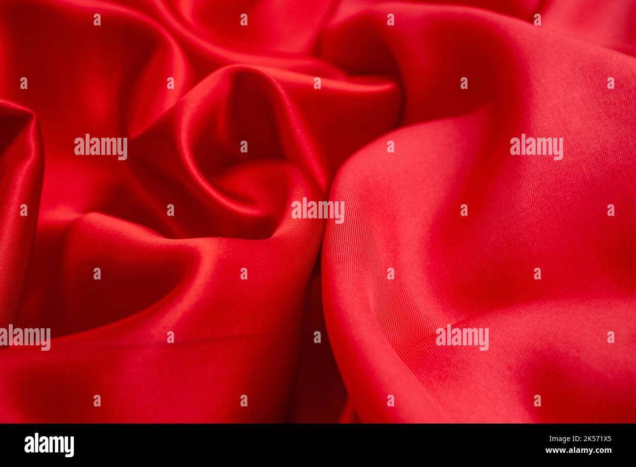 Satin vs silk textures, red fabric quality comparison, soft focus close