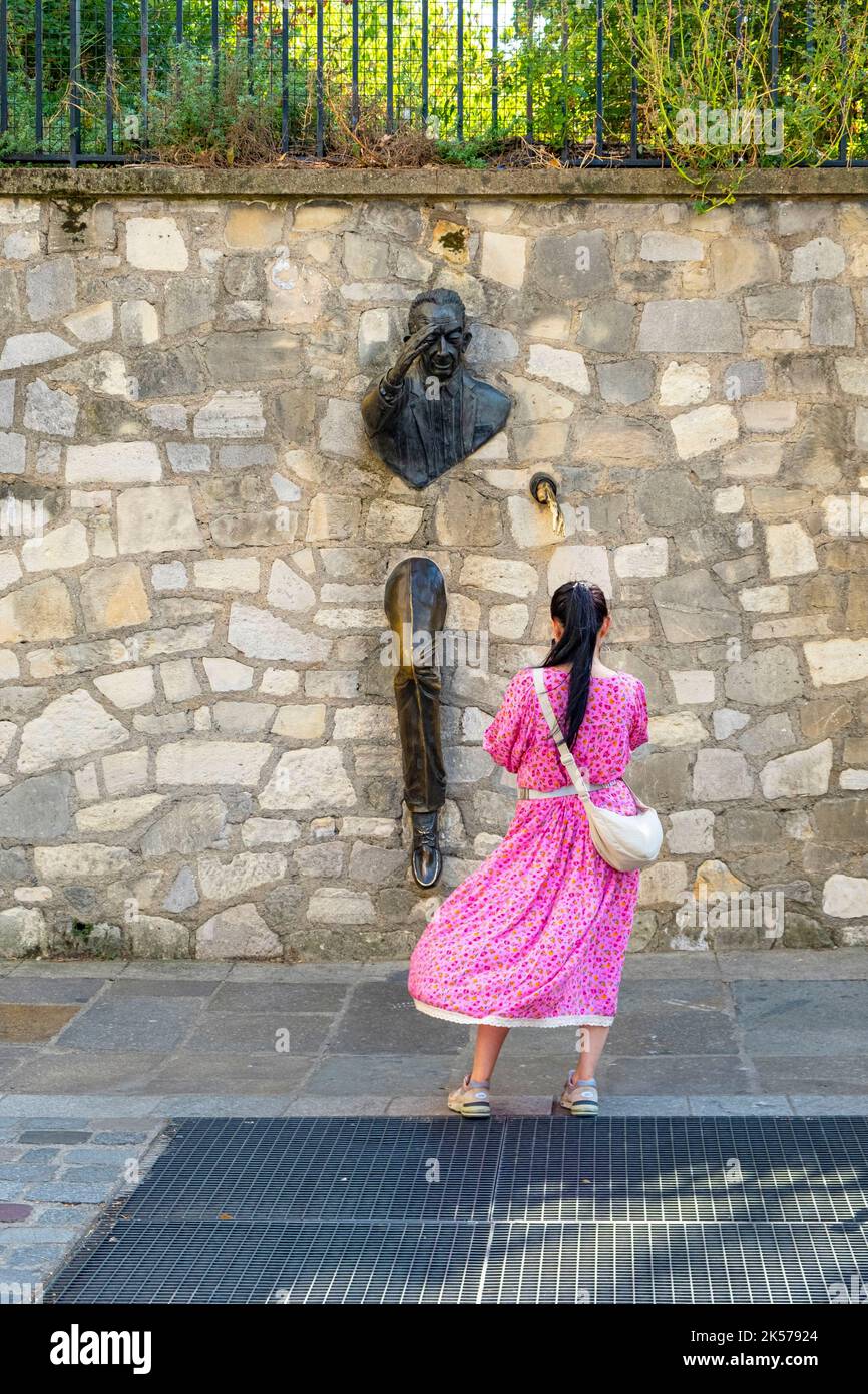 France, Paris, Montmartre, Passe-Muraille statue fixed in the wall of Place Marcel Aymé, created by actor Jean Marais in homage to the work of writer Marcel Aymé Stock Photo