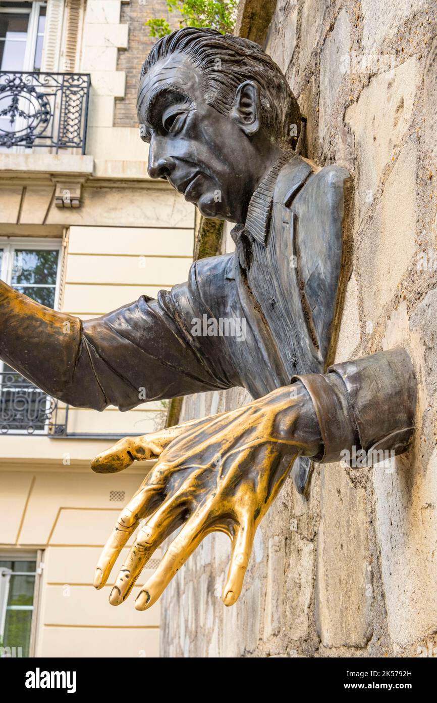 France, Paris, Montmartre, Passe-Muraille statue fixed in the wall of Place Marcel Aymé, created by actor Jean Marais in homage to the work of writer Marcel Aymé Stock Photo