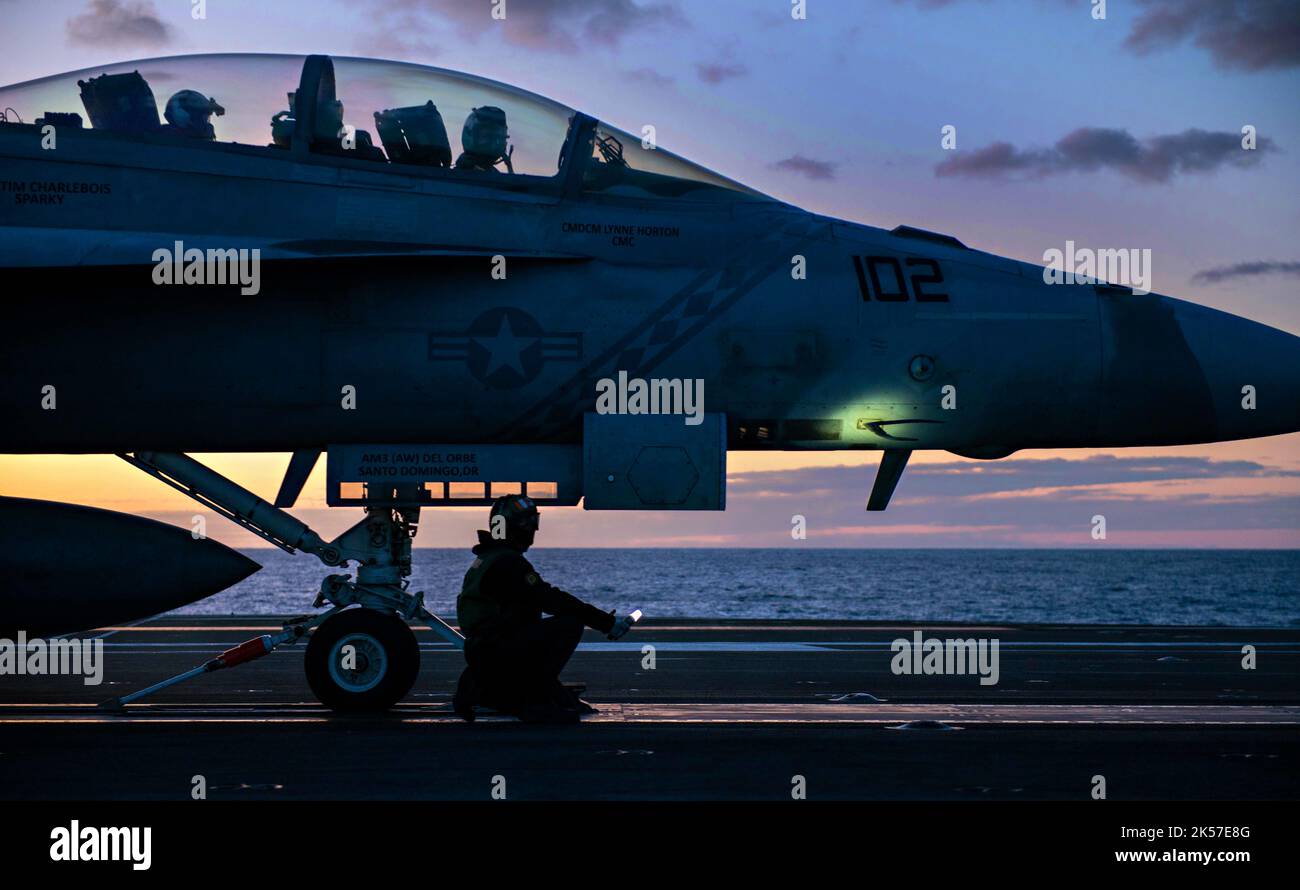USS Ronald Reagan, South Korea. 05th Oct, 2022. A U.S. Navy shooter signals a F/A-18F Super Hornet fighter aircraft, attached to the Diamondbacks of Strike Fighter Squadron 102 for take off at twilight on the flight deck of the Nimitz-class, nuclear-powered super-carrier, USS Ronald Reagan during operations in the Sea of Japan, October 5, 2022 near South Korea. Credit: MC2 Michael Jarmiolowski/US Navy Photo/Alamy Live News Stock Photo
