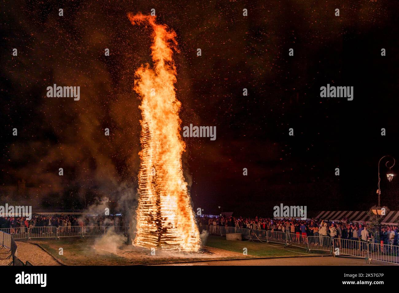 France, Eure, La Haye-de-Routot, traditional bonfire of Saint-Clair, a 15 meters high pyramid of dry wood is erected, on the village square, in front of the church and its thousand-year-old yews. A mass and a blessing precede the burning of the stake, if the cross at the top does not burn, it is a good sign for the 12 months to come, bringing back home a piece of charred wood, called brandon, will protect the house against lightning Stock Photo