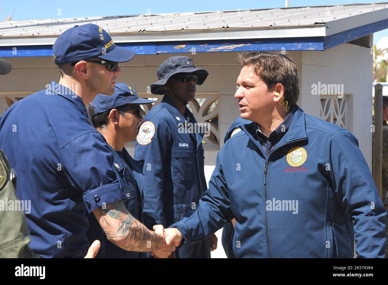 Pine Island, United States. 04th Oct, 2022. Coast Guard Lt. Nicholas Haas, left, shakes hands with Florida Governor Ron. DeSantis, during recovery work in the aftermath of Hurricane Ian, October 4, 2022 in Pine Island, Florida. Credit: PO2 Brandon Hillard/US Coast Guard/Alamy Live News Stock Photo