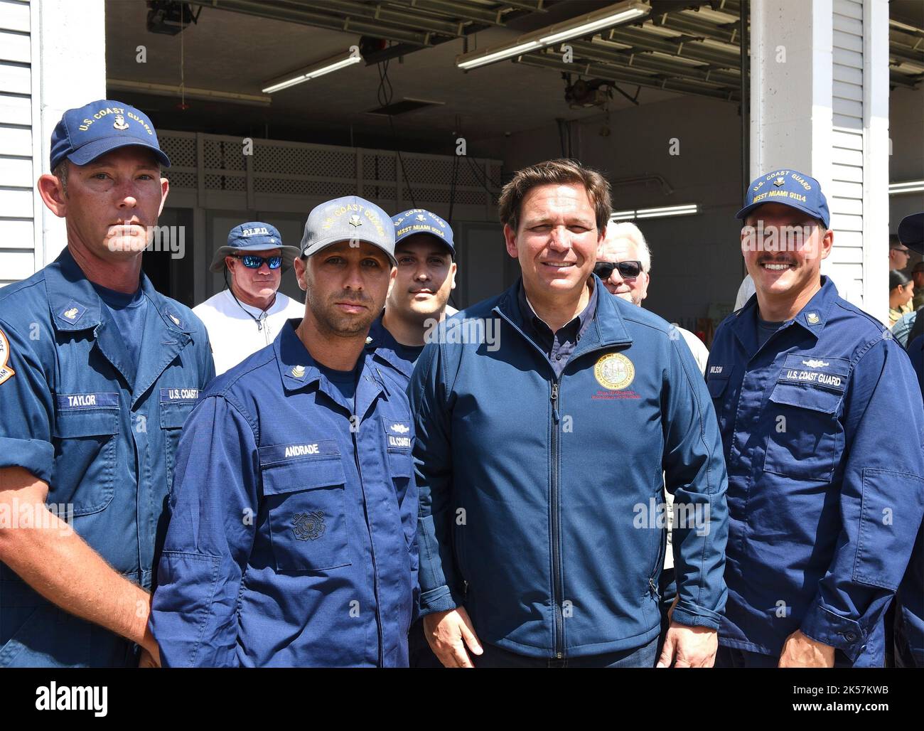 Pine Island, United States. 04th Oct, 2022. Florida Governor Ron. DeSantis, center, poses for a photo with Coast Guard members during recovery work in the aftermath of Hurricane Ian, October 4, 2022 in Pine Island, Florida. Credit: PO2 Brandon Hillard/US Coast Guard/Alamy Live News Stock Photo