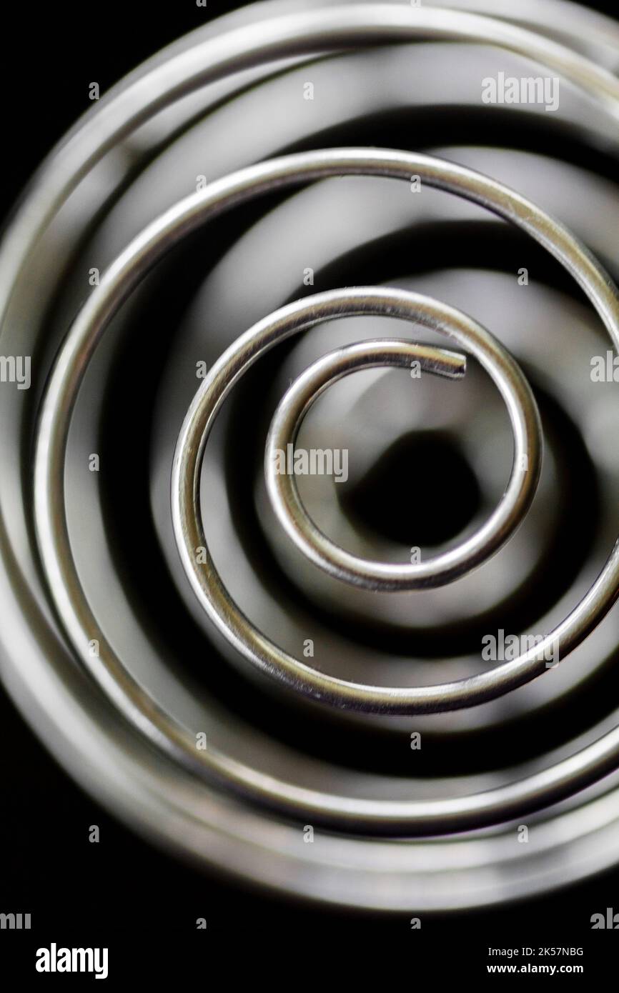 A whisk ball makes a spiral abstract design Stock Photo