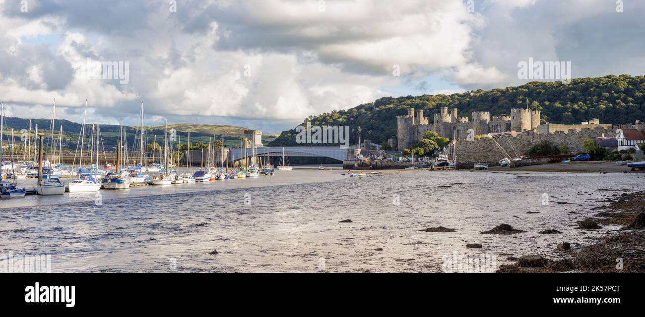 Conwy, UK, September 28th 2022: Edward I's castle stands guard over the River Conwy which is a popular mooring place for small boats and yachts. Stock Photo