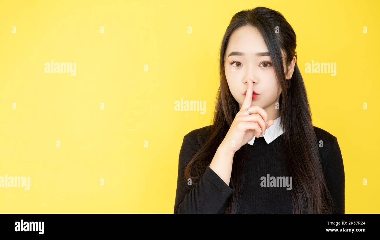 shush gesture secret sign woman finger silence Stock Photo