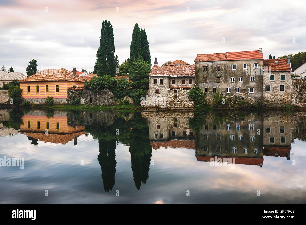 Old Town in Trebinje city. View at old town of Trebinje and Trebisnjica river with beautiful reflections.  Sunset time,  long exposure, selective focu Stock Photo