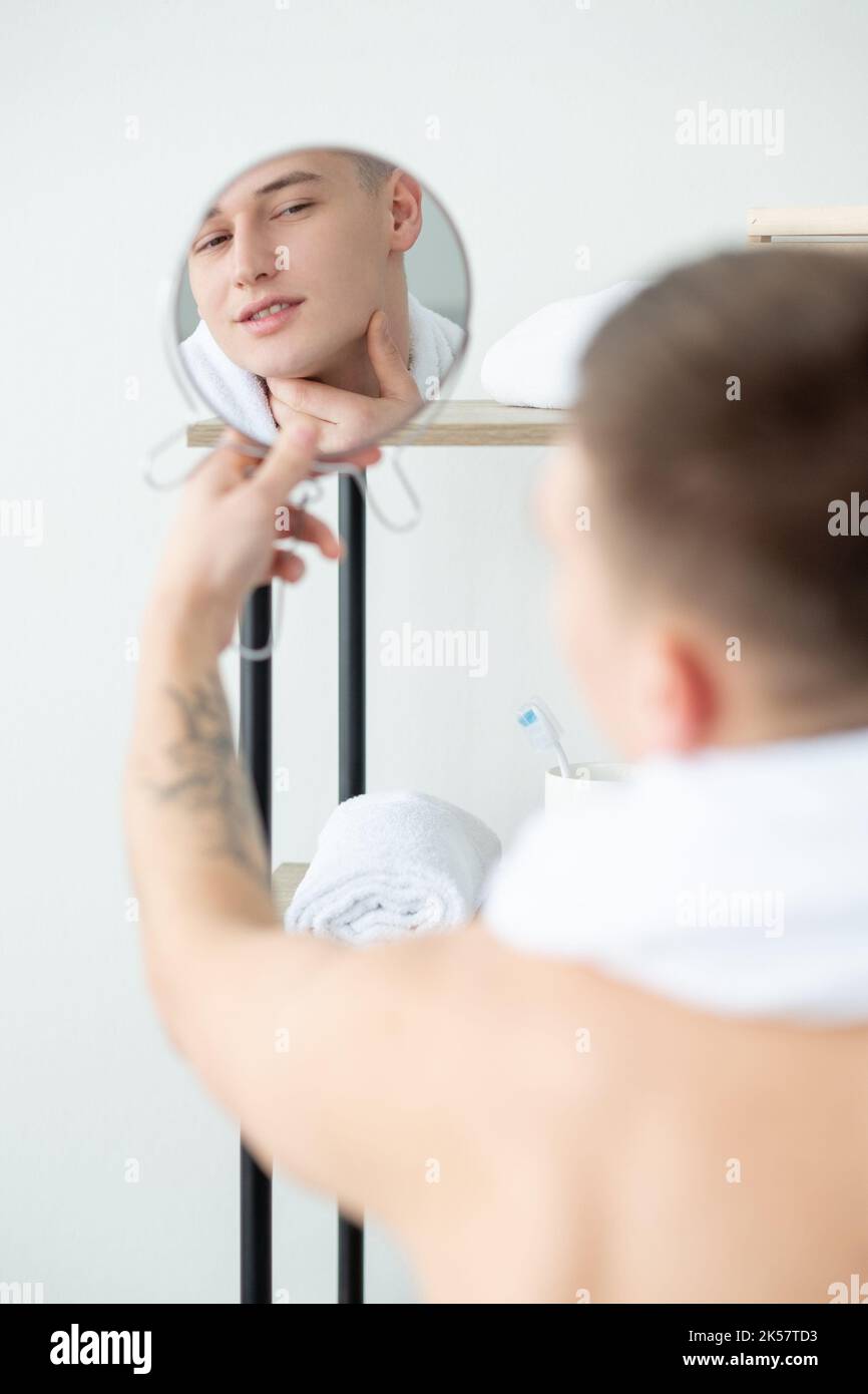 perfect skin aftershave lotion man face mirror Stock Photo