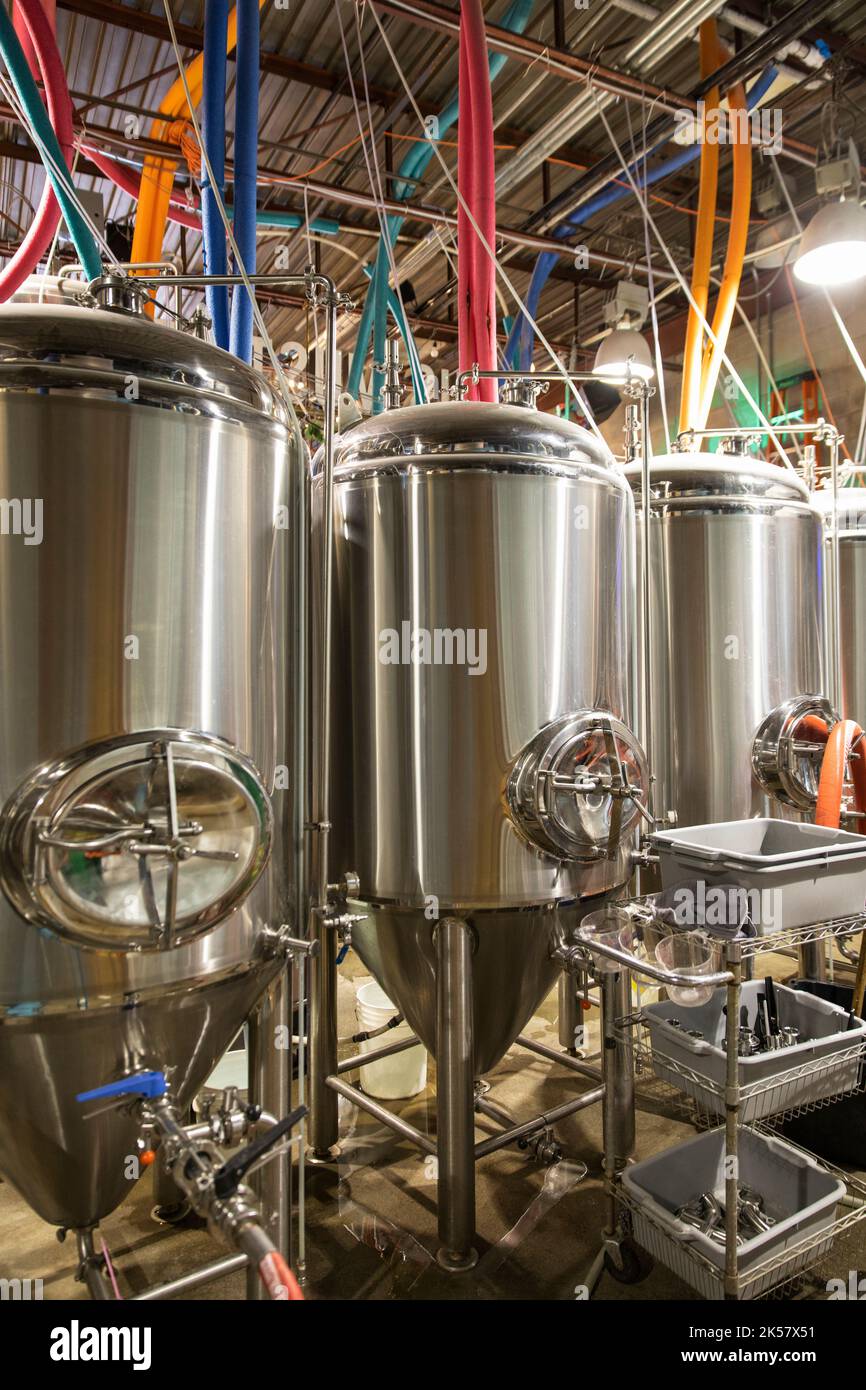 Stainless steel brewery storage tanks with colorful pipes Stock Photo