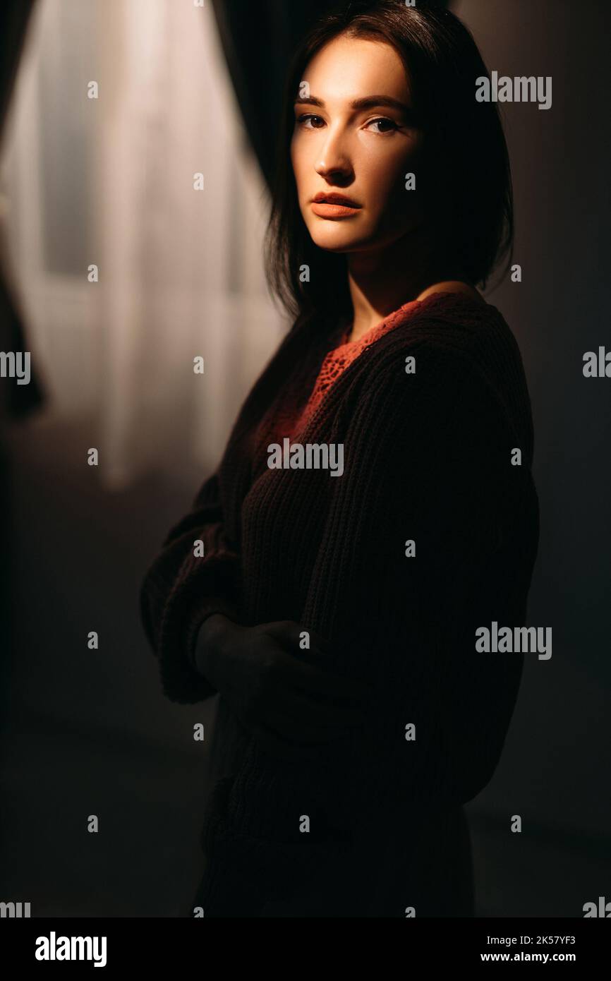 domestic violence insecure woman in dark shade Stock Photo - Alamy