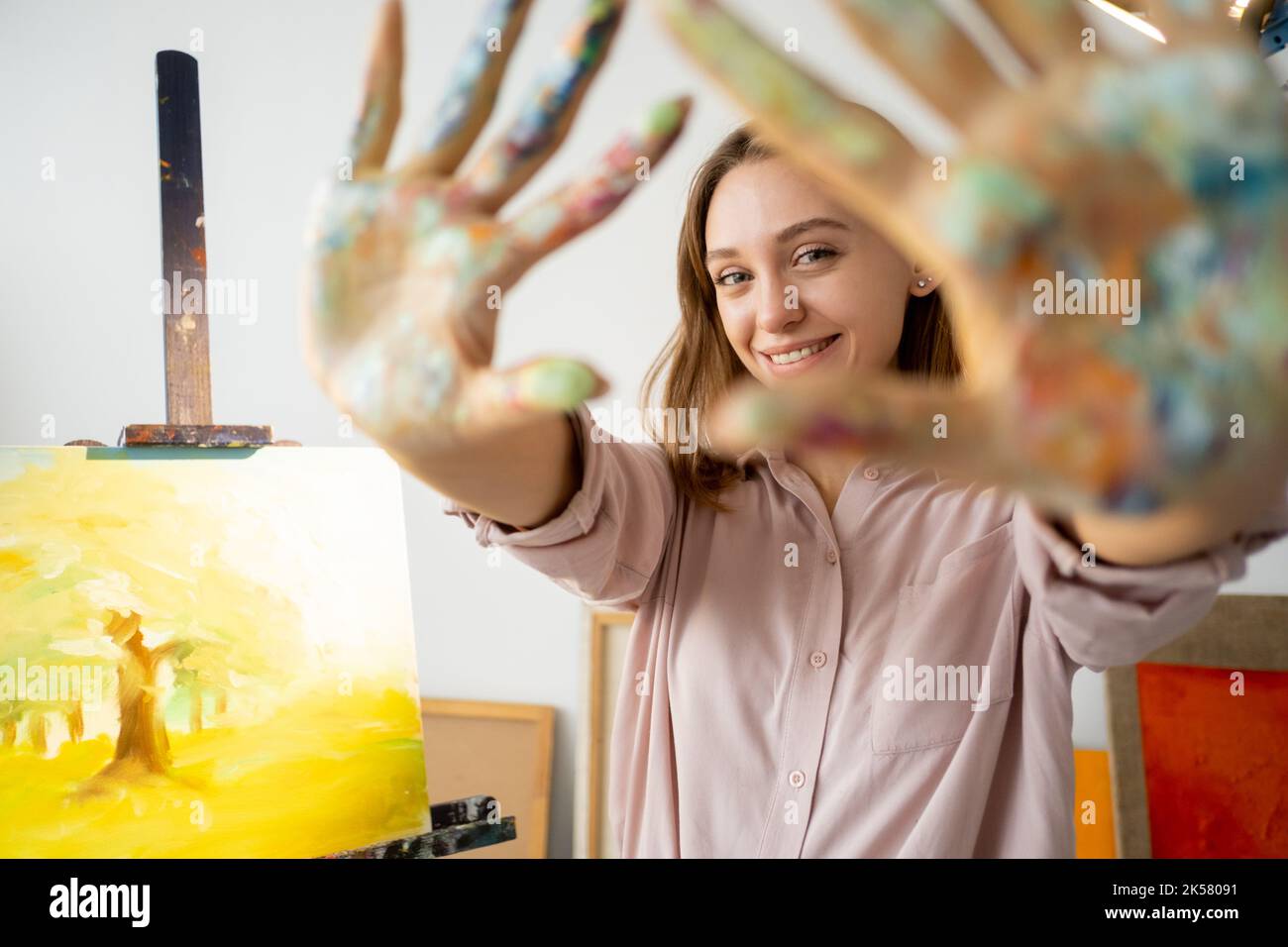 hand painting art therapy happy artist dirty palms Stock Photo