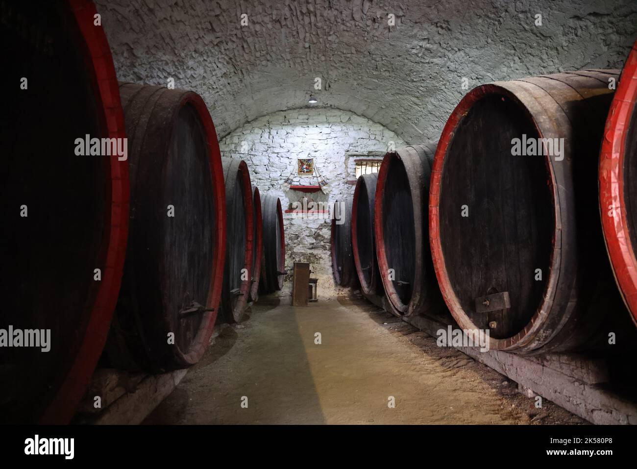 Large wooden wine barrels in the cellar of an old building of a church