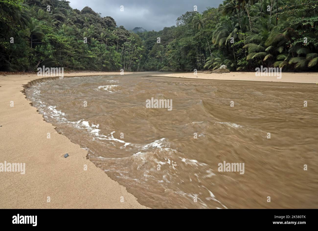 rivermouth on sandy beach on a rising tide Principe Island, Sao Tome