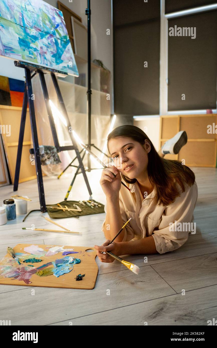 female artist painting school creating artwork Stock Photo