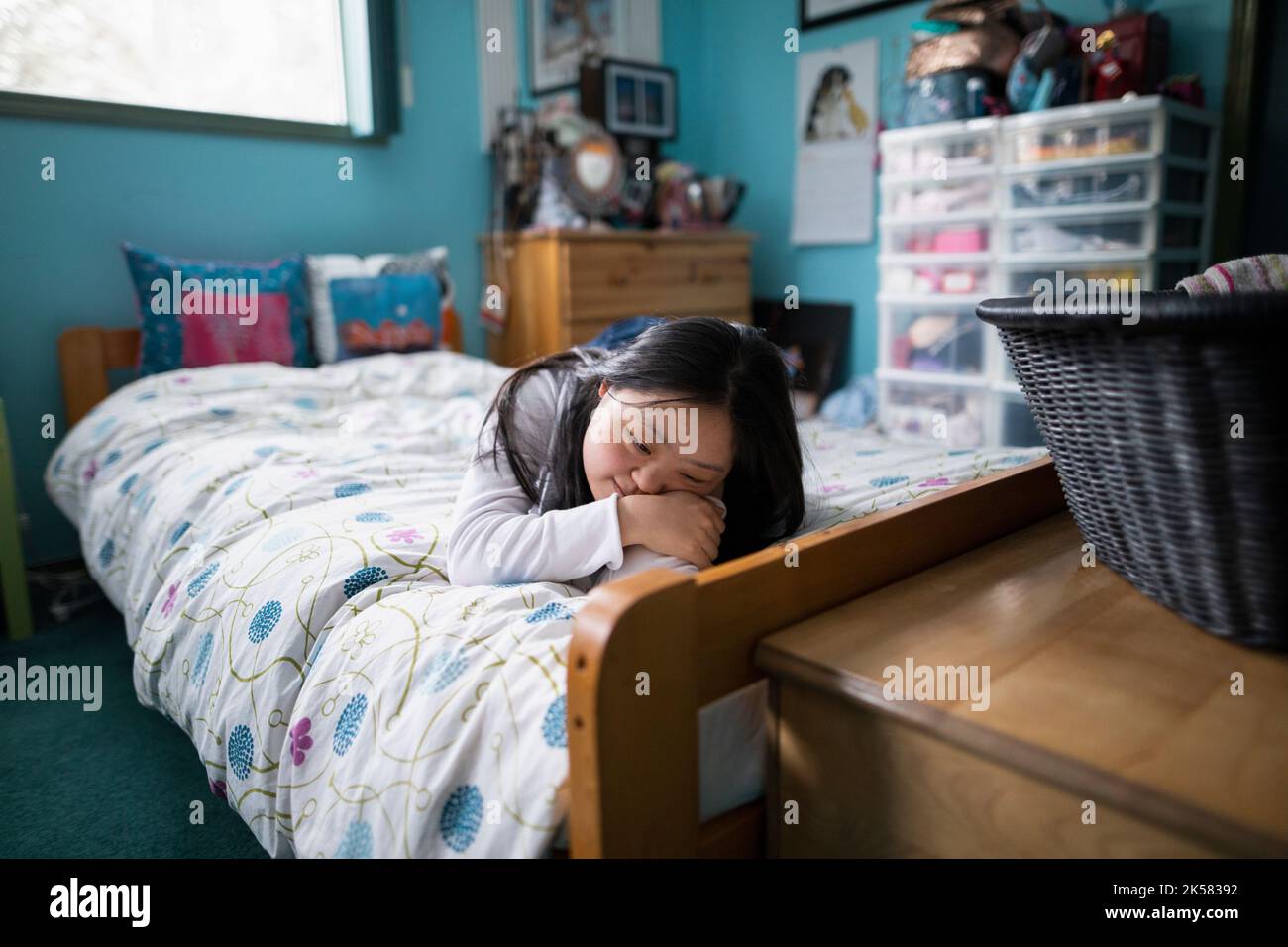 Serene young woman with Down Syndrome on bed Stock Photo Alamy