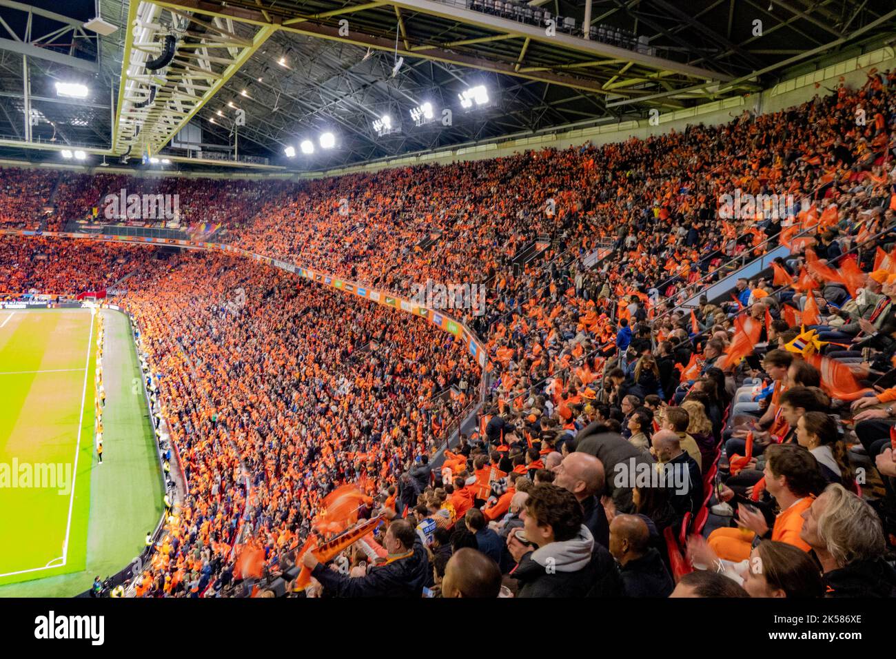 orange coloured fans at soccer game of the dutch national team in Amsterdam arena, Holland Stock Photo