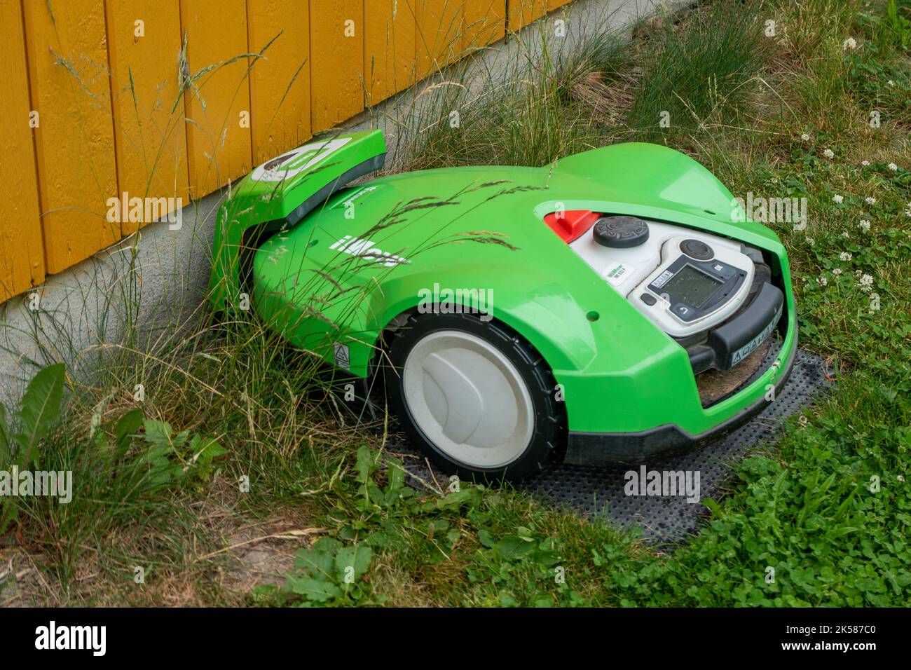 robot mower at green in Norwy Stock Photo
