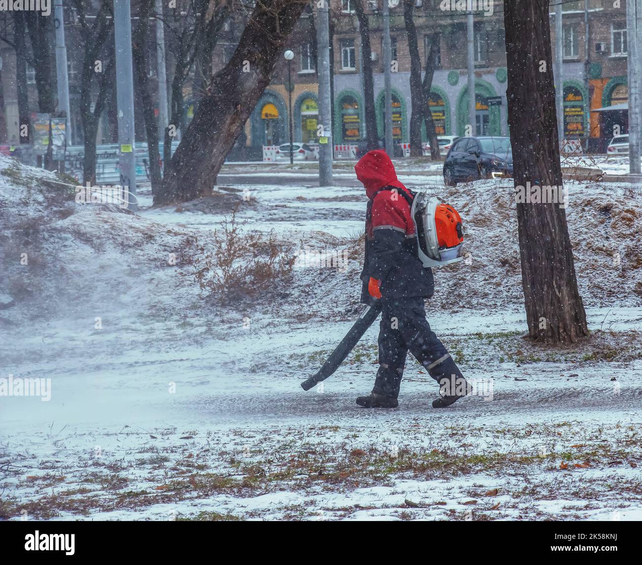 Seasonal work of city utilities in the park. A worker with a motorized