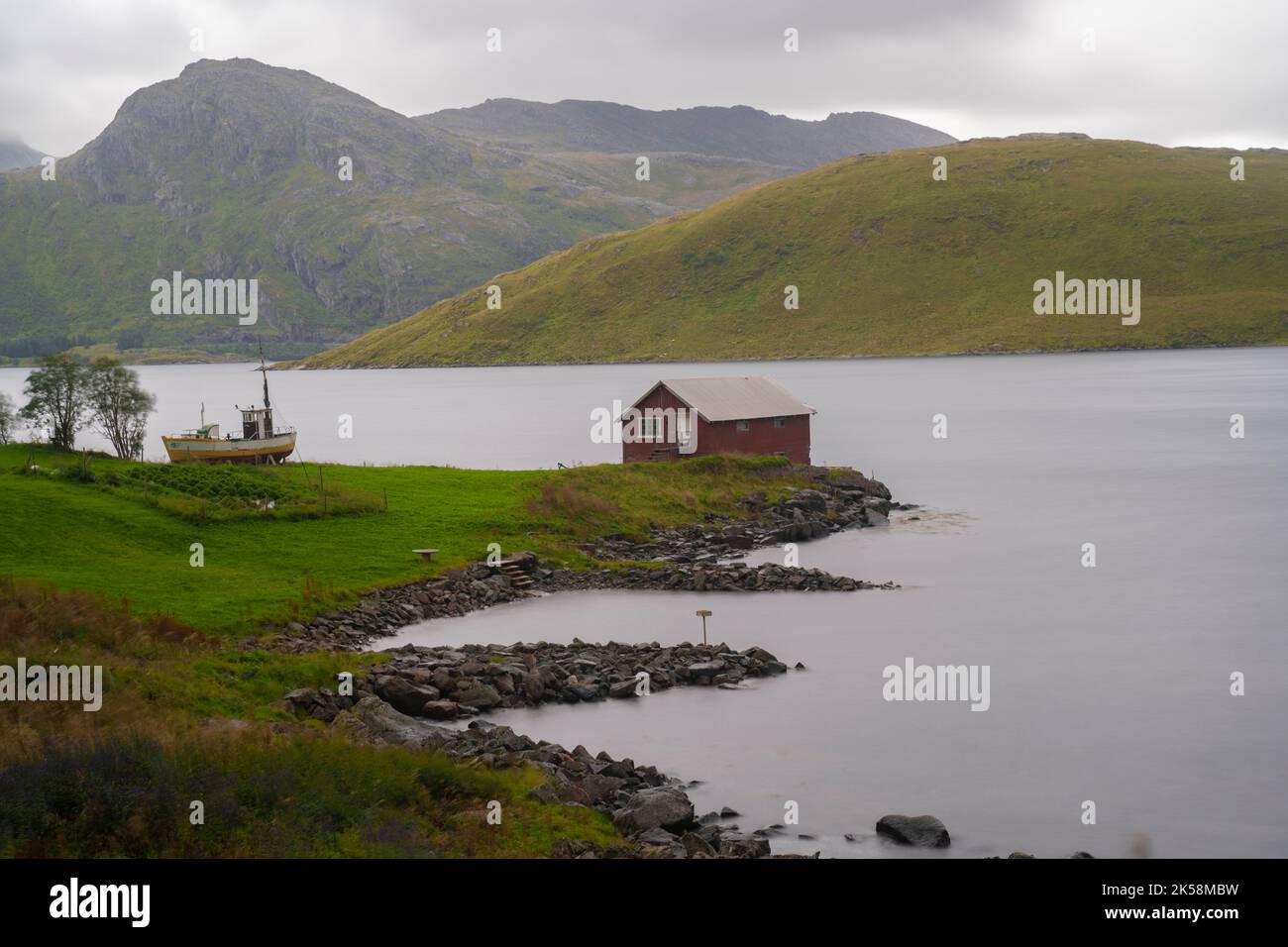 lonely cabin next to the sea in the fiords of Lofoten islands, Norway Stock Photo