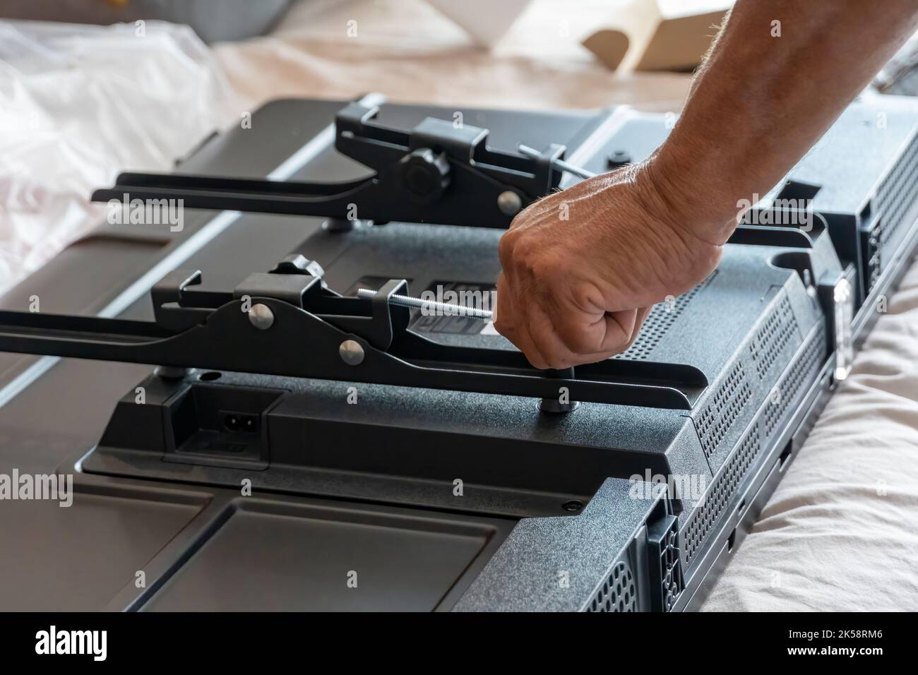 Handyman using screwdriver to fix tv, repair and installation services Stock Photo