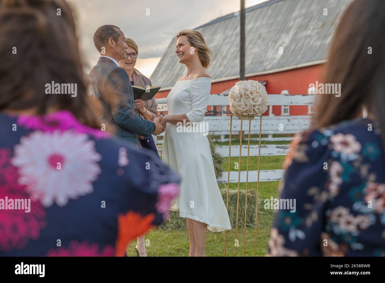 Happy mature couple reciting vows in rural field Stock Photo