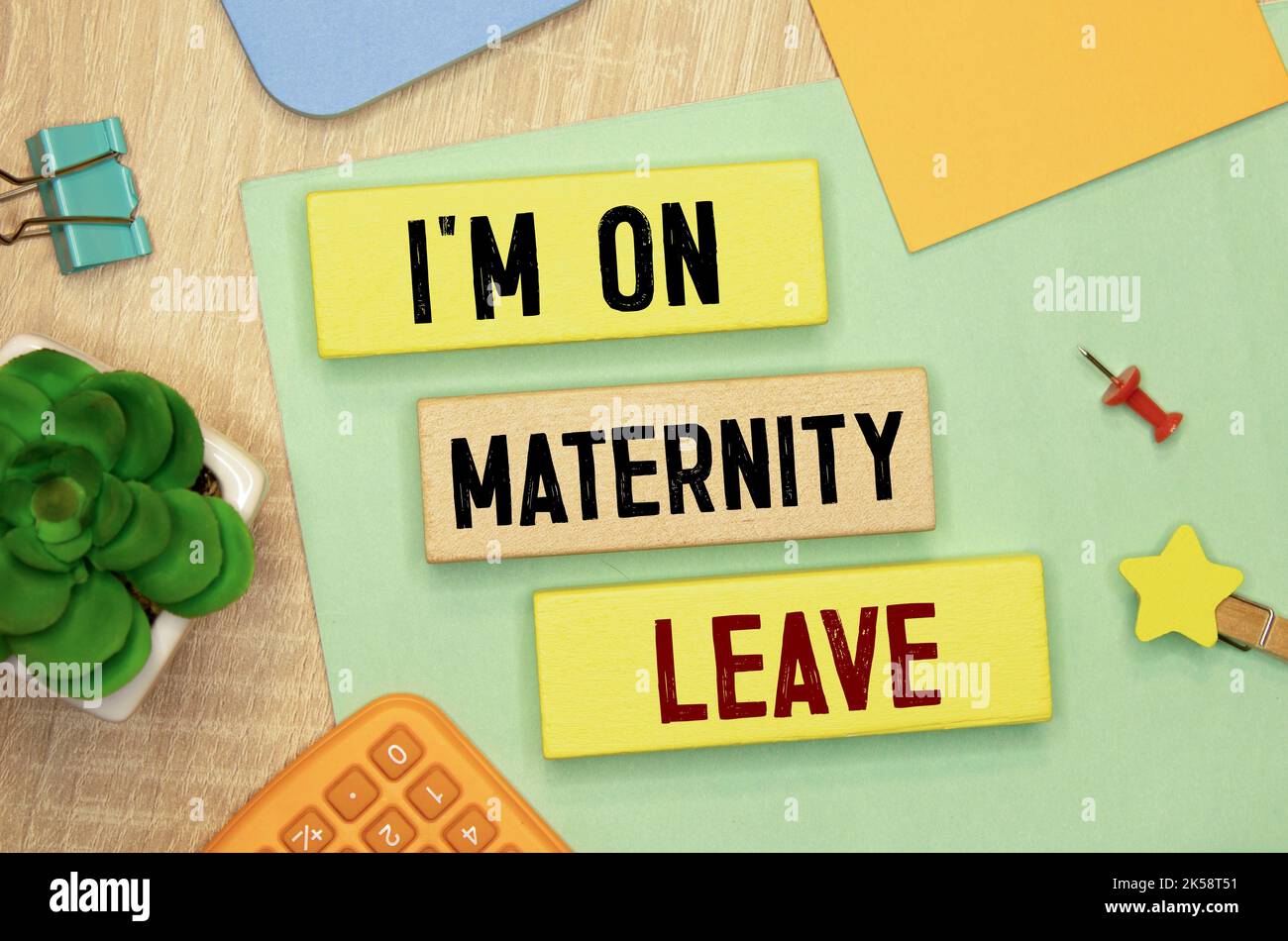 Recycled paper note pinned on cork board.I'm on Maternity Leave Message