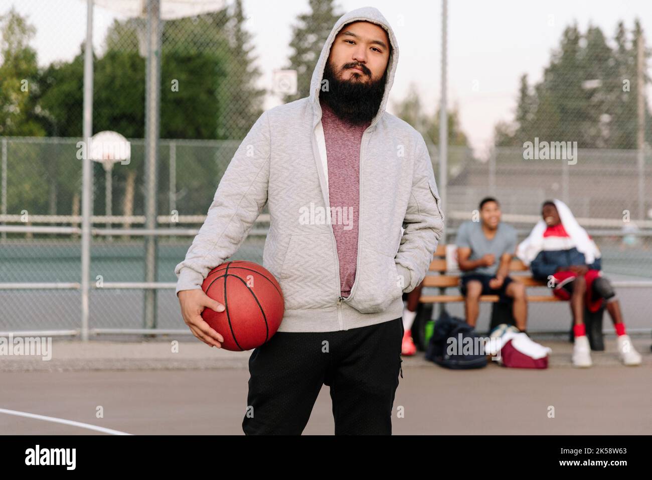 Basketball player holding ball and facing camera Stock Photo