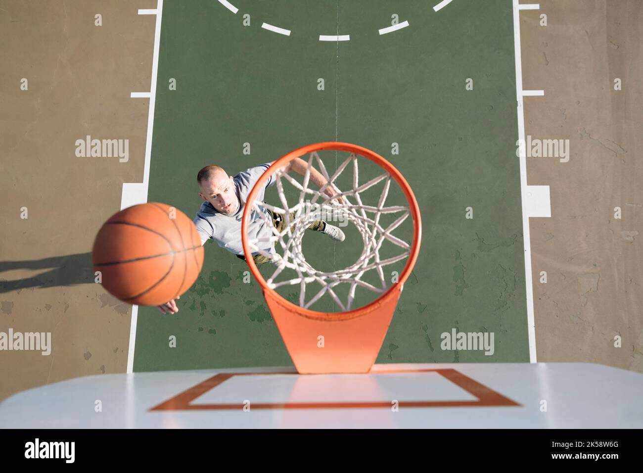 Man shooting basketball overhead view hires stock photography and