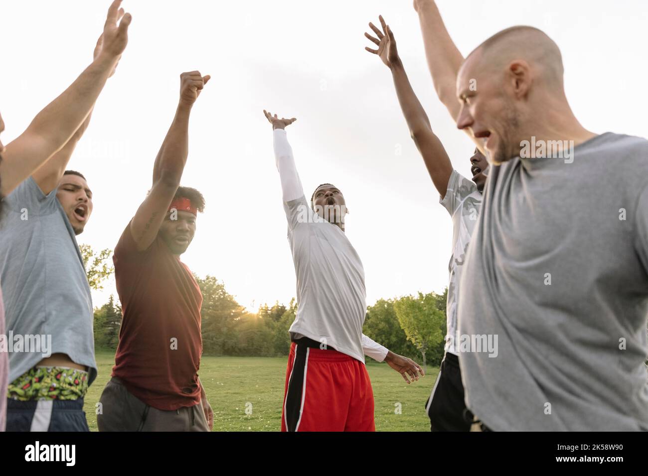 Basketball players raising arms in celebration Stock Photo Alamy