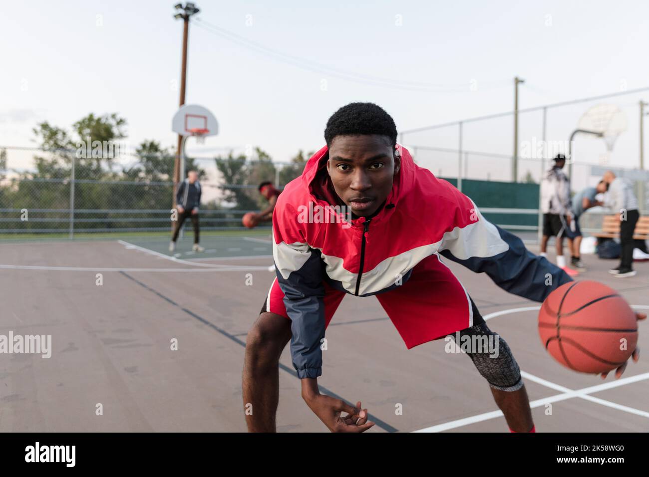 Action shot of basketball player with ball facing camera Stock Photo