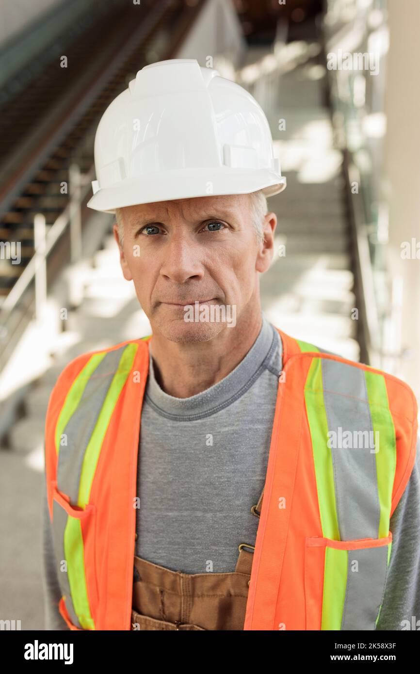Construction wearing hard hat vest hires stock photography and images