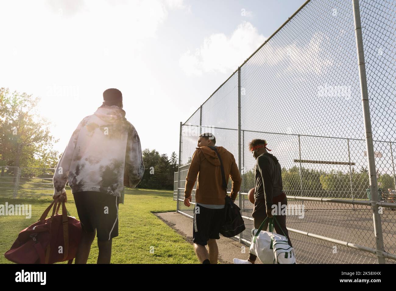 Basketball players carrying bags and leaving basketball court Stock