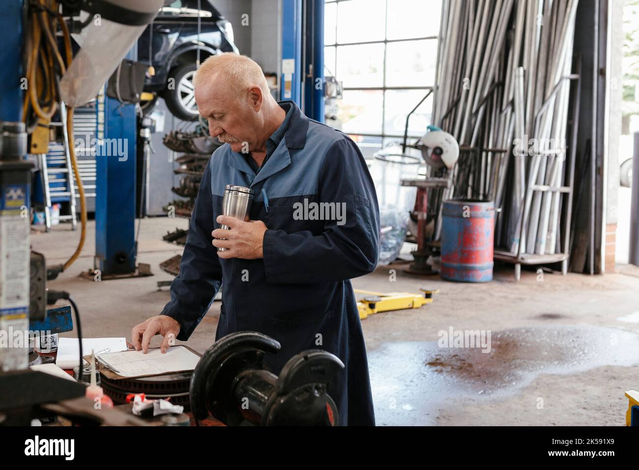 Mechanic wearing overalls working in with coffee Stock Photo Alamy