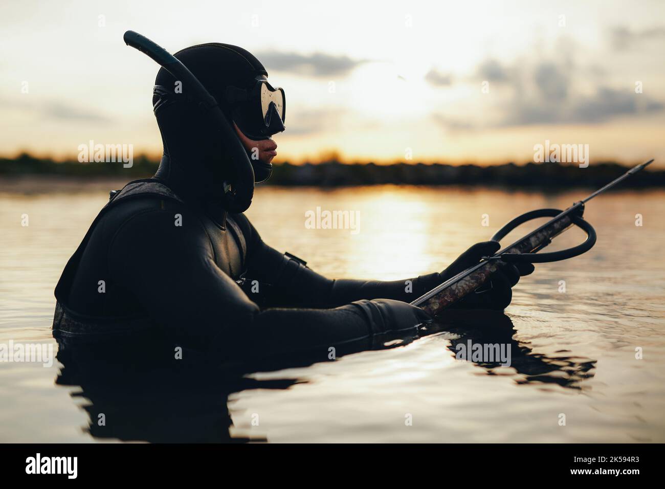 Young man spearfishing using a speargun in the sea. Adventurous young