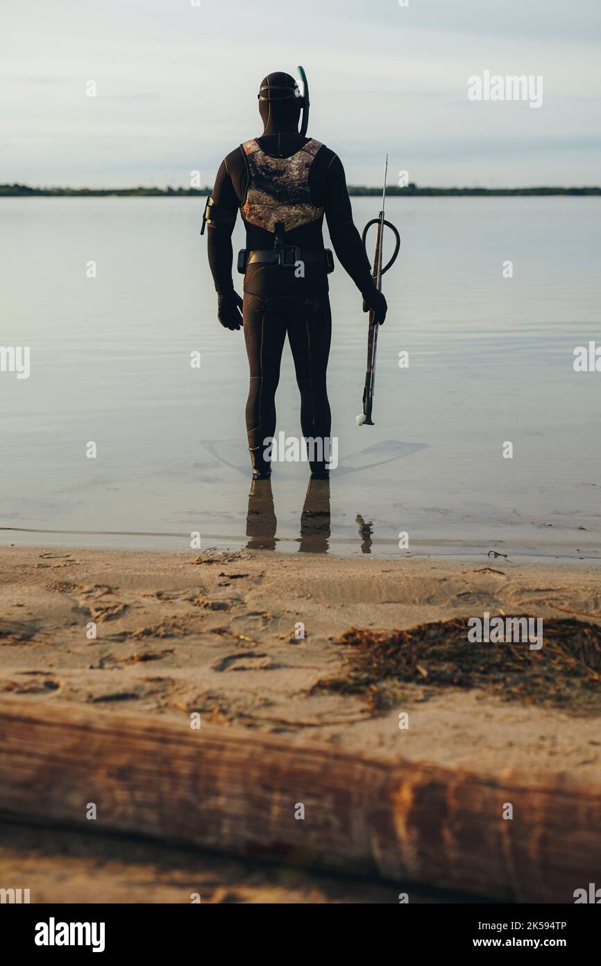 Spearfishing A Man In A Wetsuit With A Harpoon Gun Stock Photo