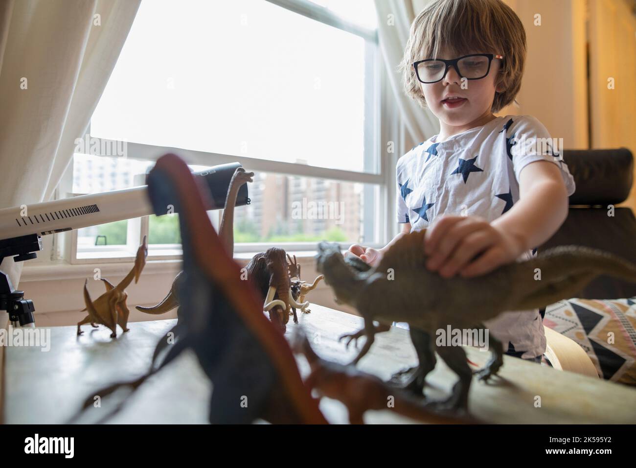 Boy holding toy dinosaur hi-res stock photography and images - Alamy