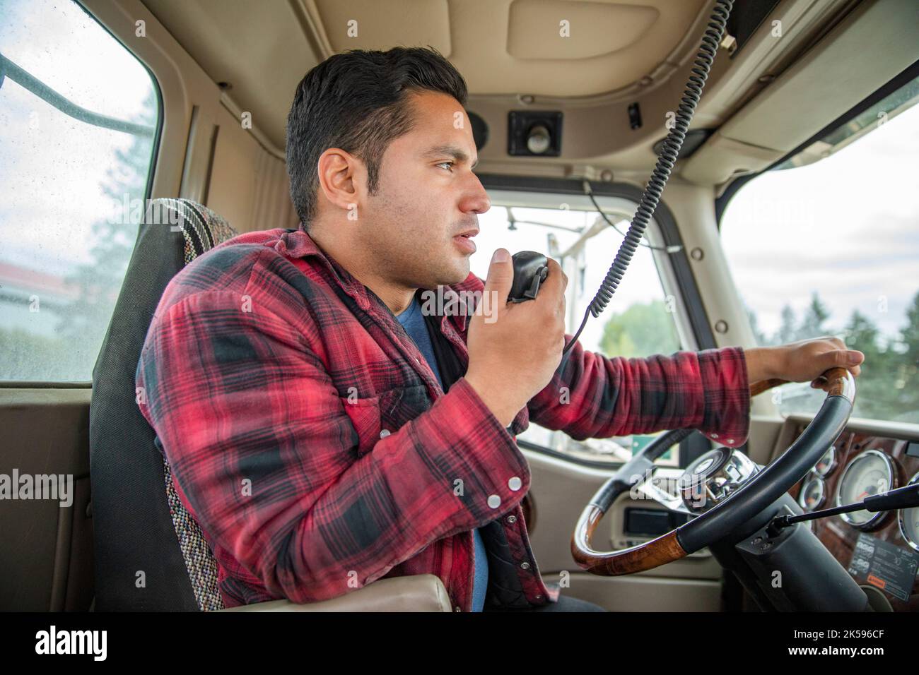 Male farmer talking on CB radio inside semi truck Stock Photo Alamy