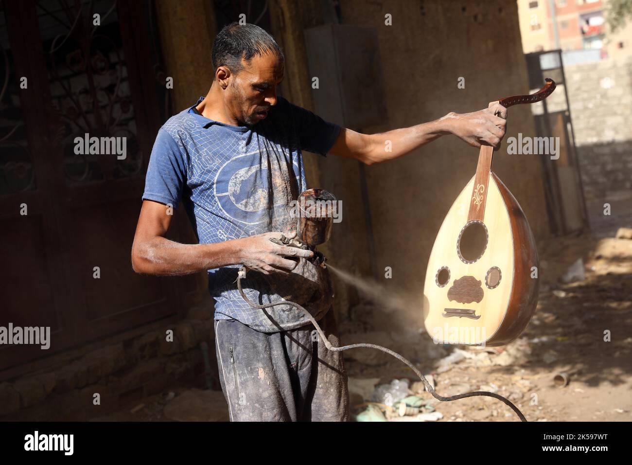 Cairo, Egypt. 27th Sep, 2022. A worker colors an oud at a workshop in ...
