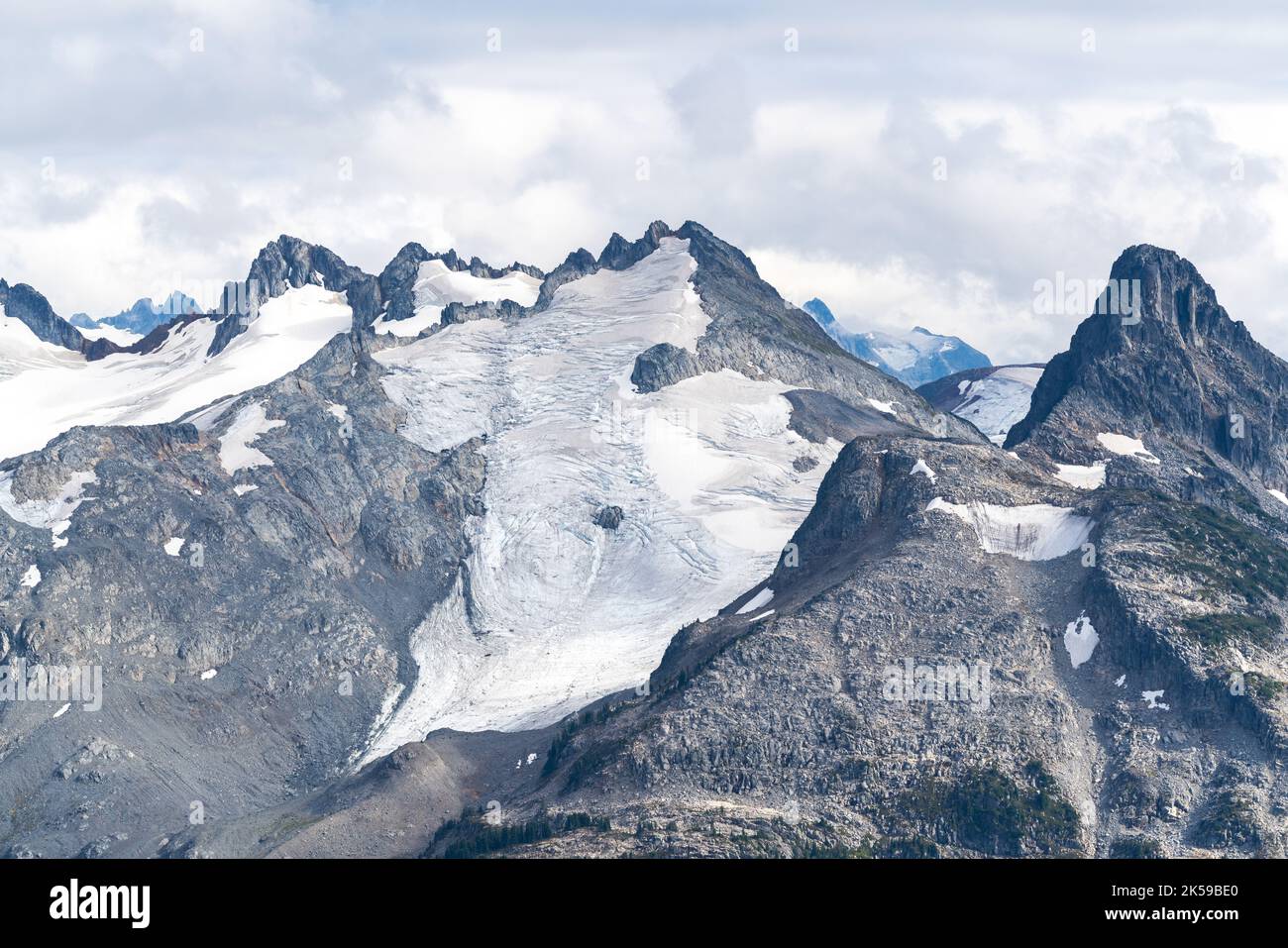Rugged peaks and glaciers across Garibaldi Lake from Panorama Ridge. Stock Photo