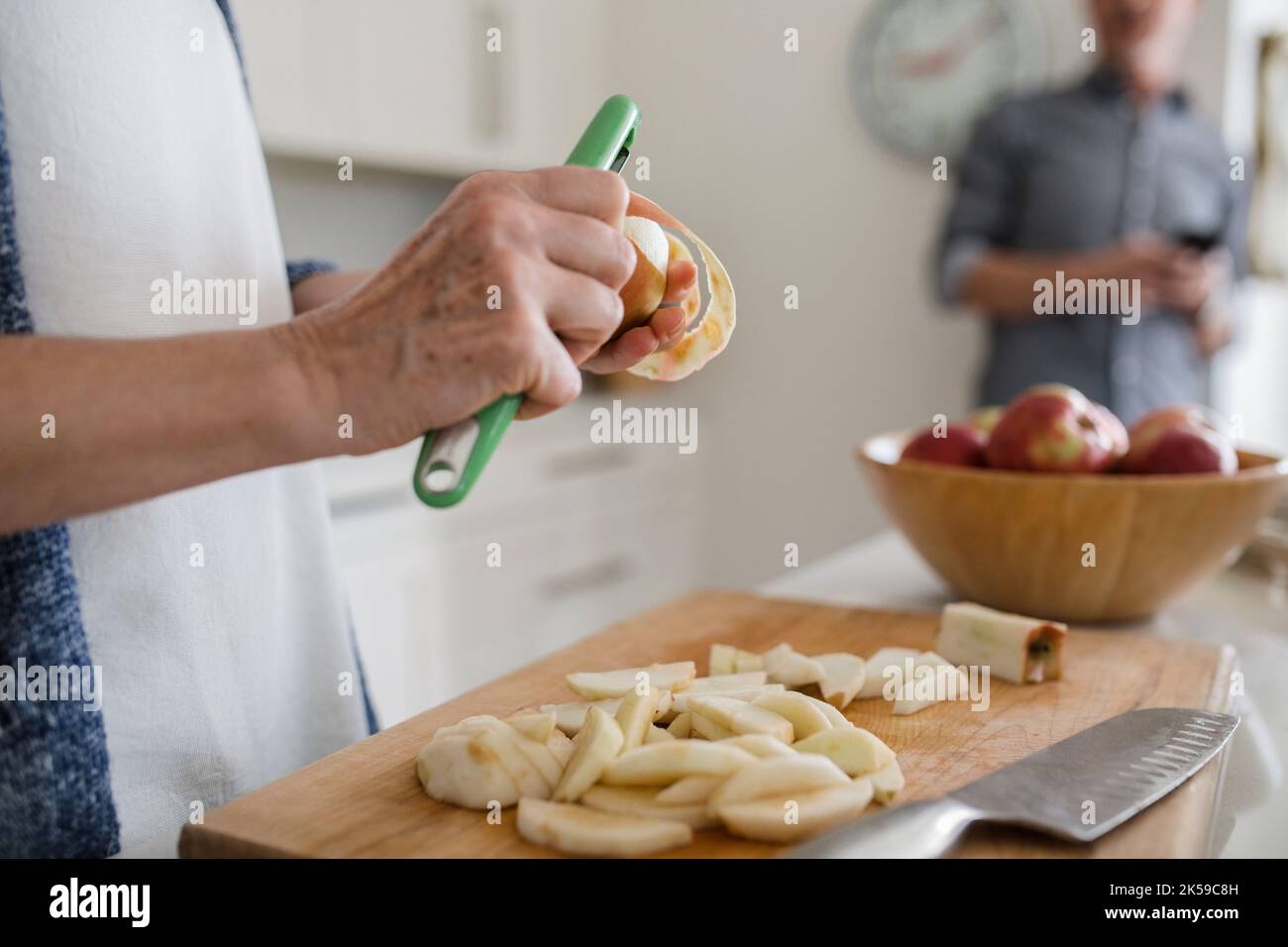 Woman peeling apple for apple pie Stock Photo Alamy