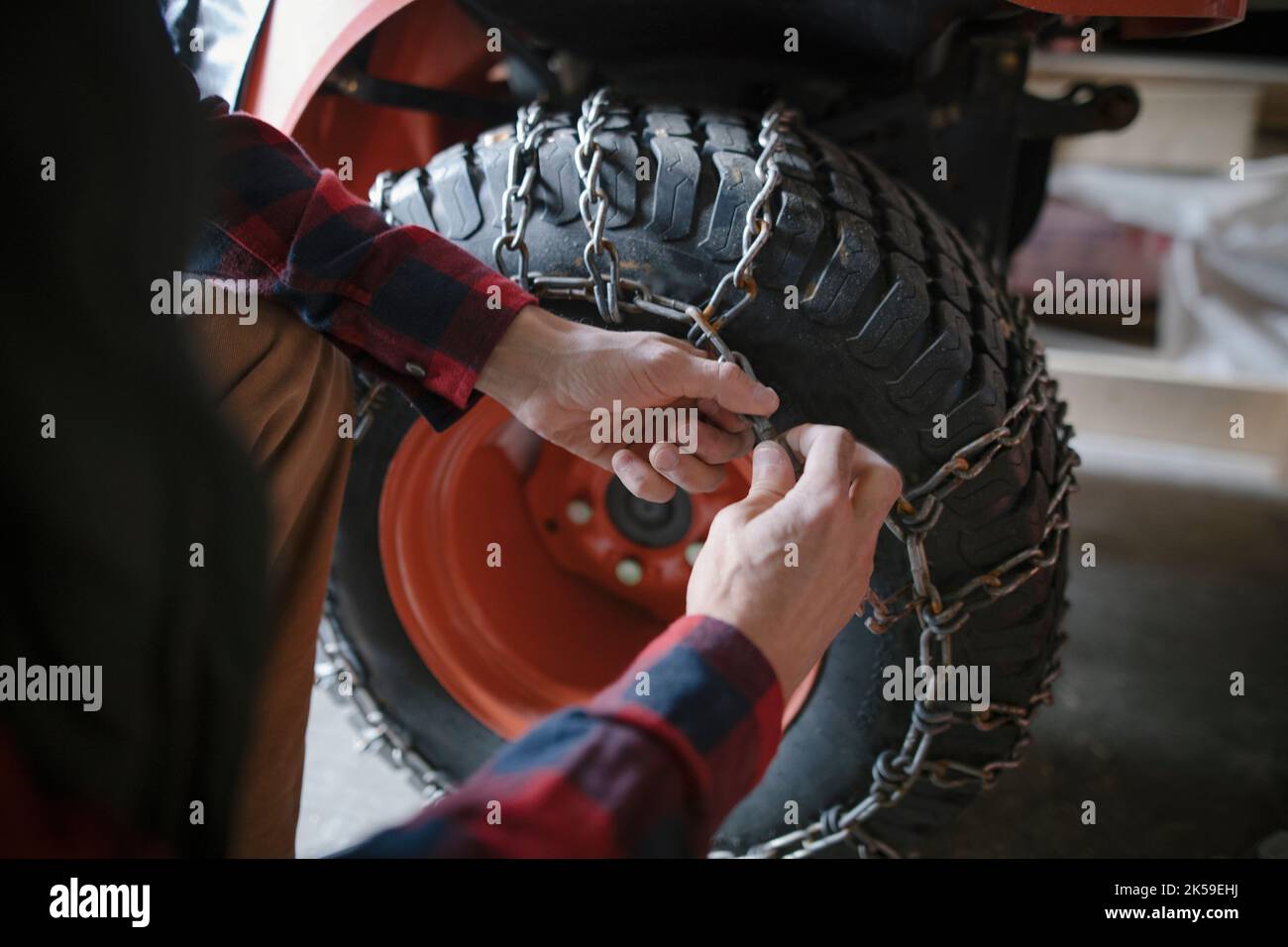 Close up man putting snow chains on quadbike tire Stock Photo Alamy