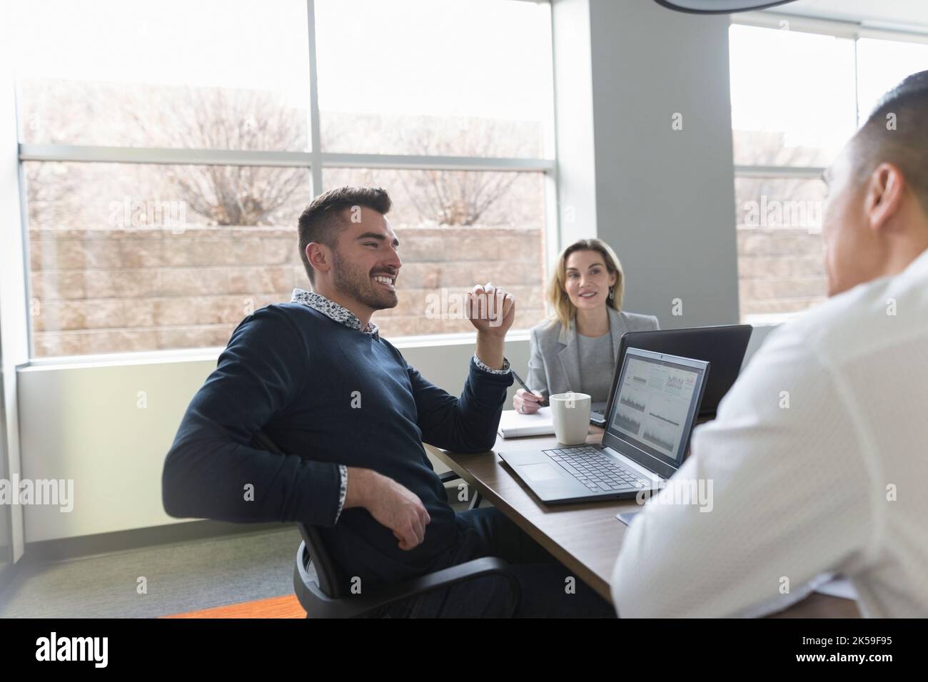 colleagues sitting in meeting room with laptops Stock Photo Alamy