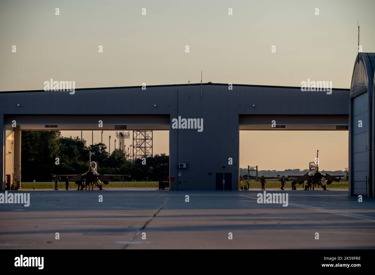 U.S. Air Force F-16 Fighting Falcons, assigned to the Ohio National Guard’s 180th Fighter Wing, sit in a hangar before a nighttime training flight at the 180FW in Swanton, Ohio, Aug. 22, 2022. The 180FW conducts training, rain or snow, day and night, to enhance mission readiness, ensuring effective combat power can be delivered to combatant commanders, anytime, anywhere.  (U.S. Air National Guard photo by Staff Sgt. Kregg York) Stock Photo