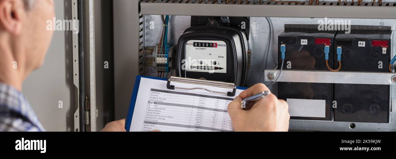 Electricity Counter Metering System. Engineer Reading Meter Stock Photo